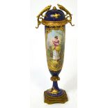 A late 19th century Sèvres cylindrical vase with cover cobalt blue ground with vignettes painted
