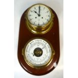 A brass Schatz Royal Mariner ship's clock and barometer set on a shaped wooden plaque, length 43cm.