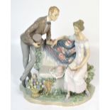 A large Lladró figurine of an Edwardian courting couple,