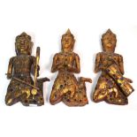 Three 20th century Balinese carved and gilded figurines of musicians decorated with mirror and
