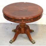 A circular mahogany inlaid table with central oval cartouche and pierced rim to the side on