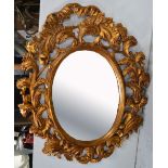 A large vintage gilded wood Rococco style framed mirror with bevelled edge,