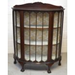 A mid 20th century mahogany display cabinet with one central drawer and glass panels to either side