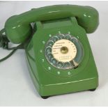 A vintage Telic green telephone with original wall mount.