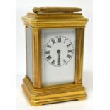 An early 20th century small brass carriage clock the enamel dial set with Roman numerals height 8cm.