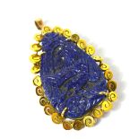 A Chinese yellow metal carved lapis lazuli pendant decorated with an exotic bird in flight,