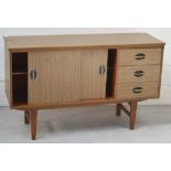 A retro three drawer/two sliding door sideboard on tapering block supports, width 121cm.