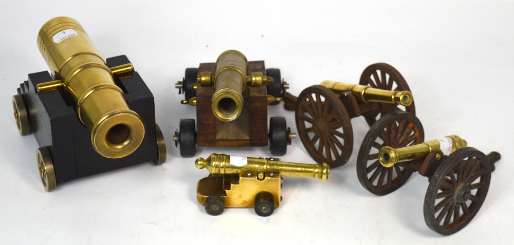 Five brass models of cannons, the longest barrel being 23cm long.