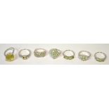 Seven silver dress rings set with pale green stones (7).