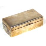 A hallmarked silver cigarette box with wood lining, London date marks rubbed, length 18cm.