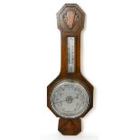 A mid 20th century oak aneroid barometer length 62cm.