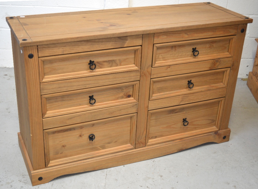 A modern pine six drawer chest of drawers on plinth base, length 132cm.