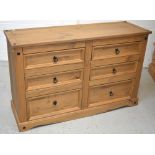 A modern pine six drawer chest of drawers on plinth base, length 132cm.