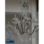 A bronzed metal effect and ten branch cut glass chandelier, length 76cm.