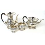A silver plated four piece tea service with engraved decoration and beaded foot.