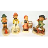 Four Hummel figures to include a young girl feeding geese, a young girl with basket,