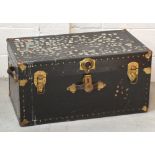 A black 20th century trunk with brass fittings and stud decoration, width 80cm.