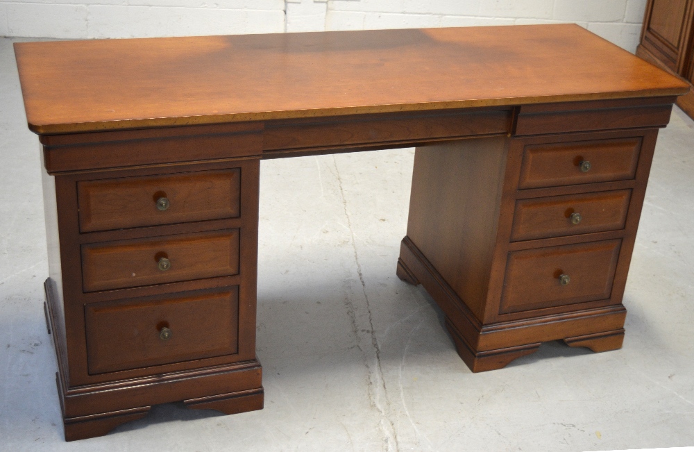 A 20th century mahogany kneehole desk, three drawers either side on bracket feet, length 151cm.