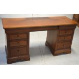 A 20th century mahogany kneehole desk, three drawers either side on bracket feet, length 151cm.