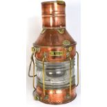 A copper and brass ship's oil lamp with ribbed clear glass lenses, the lamp with rear access gate,