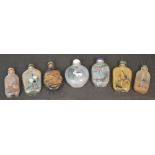 A group of seven Chinese glass scent bottles decorated with various animals and landscapes,