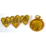 An early 20th century yellow metal triple heart brooch with marks to the back and a yellow metal