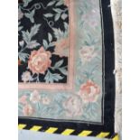 A large black ground floral decorated Chinese Superwash carpet, 390 x 275cm.