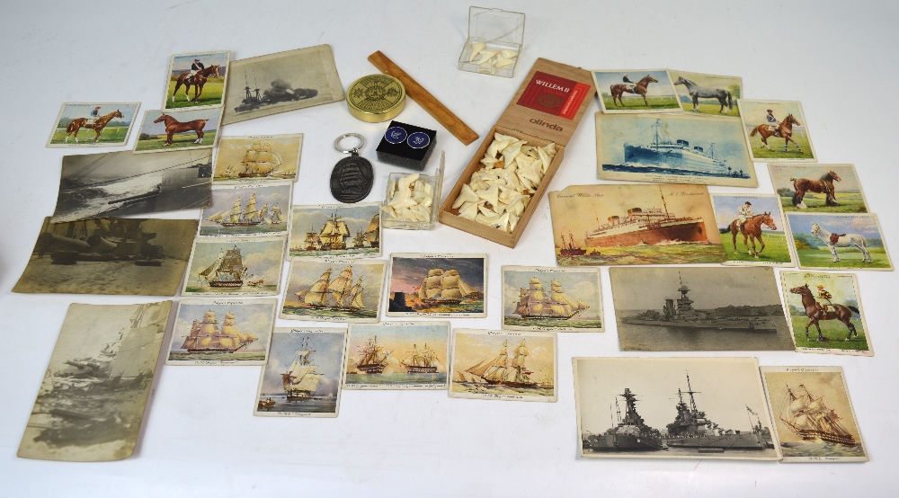 A maritime collector's lot comprising postcards, cigarette cards, whale teeth etc.