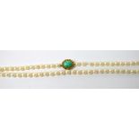 A cultured pearl necklace with yellow metal clasp set with oval turquoise cabochon,