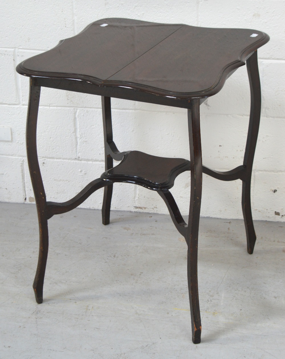 An Edwardian occasional table with lower tier on cabriole legs, width 57cm.