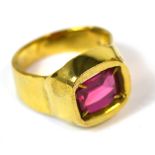 A gentleman's 18ct gold dress ring set with a large emerald cut ruby, size T, approx 17g.