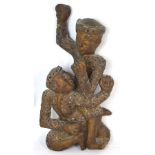 A 20th century carved Balinese figurine of two male figures wrestling. *Provenance: Professor B.