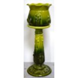 An early 20th century Art Nouveau Bretby jardinière and stand in graduating shades of lime green,