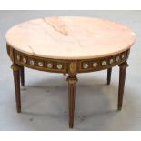 A round marble top table on a gilded base with vignettes of flowers.