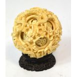 A large late 19th century Chinese carved ivory puzzle ball decorated with dragons,