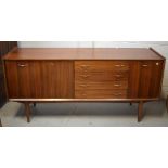 A retro teak sideboard with four central drawers and cupboards either side, on tapering legs,