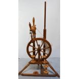 A 20th century oak spinning wheel.