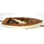 A small white painted sailing boat, length approx 70cm.