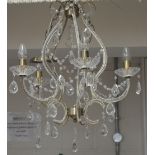 A bronzed metal effect and cut glass five branch chandelier, length 64cm.