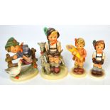 Four Hummel figures to include a young boy with hands in pockets with lambs,