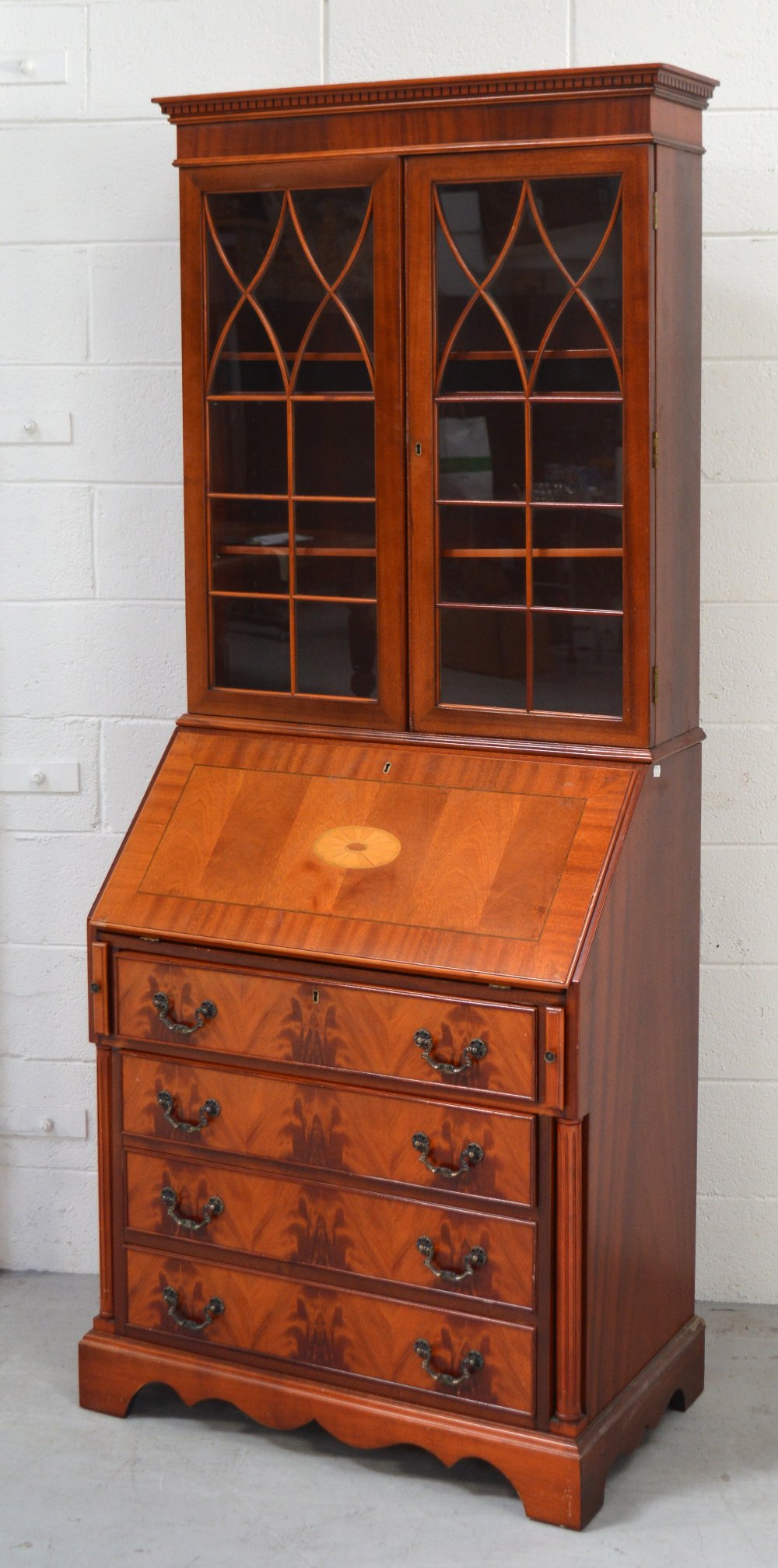 A reproduction bureau bookcase with astragal glazed doors, width 78cm.