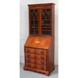 A reproduction bureau bookcase with astragal glazed doors, width 78cm.