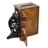 An oak cased microscope.