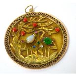 A Chinese yellow metal pendant with a pierced metal border and central raised panel decorated with