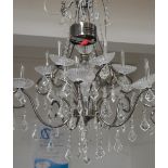 A bronzed metal effect and ten branch cut glass chandelier, length 76cm.