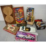 A large quantity of toys to include a boxed Barbie Ferrari, further Barbie dolls and accessories,