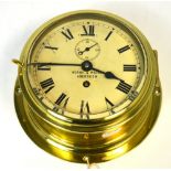 A brass ship's clock with circular dial inscribed 'Berry' and signed Mackay Aberdeen, diameter 20cm.