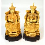 A pair of early 20th century carved ivory figures of the emperor and empress both elaborately