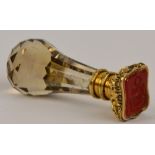 A 19th century facet cut smoky quartz seal with finely detailed embossed yellow metal cap set with