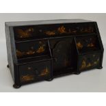 An 18th century black lacquered chinoiserie decorated miniature table top bureau,